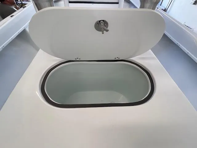 Slide: The Image of 1986 Aquasport Tournament 222 boat livewell with open lid, showcasing interior. - 29