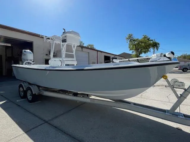 Slide: The Image of 1986 Aquasport Tournament 222 boat on trailer, parked outside a garage. - 9