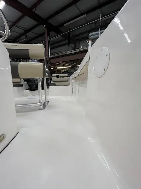 Slide: The Image of 2019 Tidewater 180CC Adventure boat interior, showcasing sleek white deck and seating. - 10