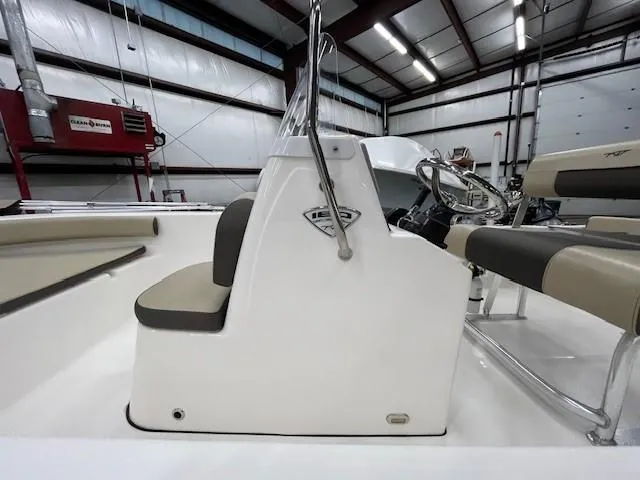 Slide: The Image of 2019 Tidewater 180CC Adventure boat interior with steering console in a warehouse setting. - 11