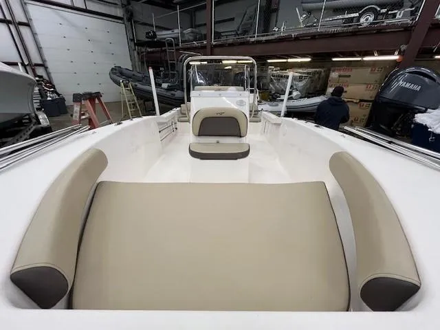 Slide: The Image of 2019 Tidewater 180CC Adventure boat interior with beige seating in a storage facility. - 13
