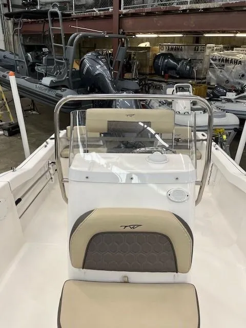 Slide: The Image of 2019 Tidewater 180CC Adventure boat interior with console and seating in a showroom. - 15