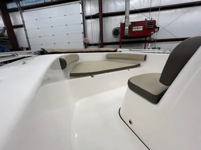Slide: The Image of 2019 Tidewater 180CC Adventure boat interior with seating, in a storage facility. - 19