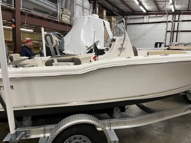 Slide: The Image of 2019 Tidewater 180CC Adventure boat on trailer in warehouse setting. - 2