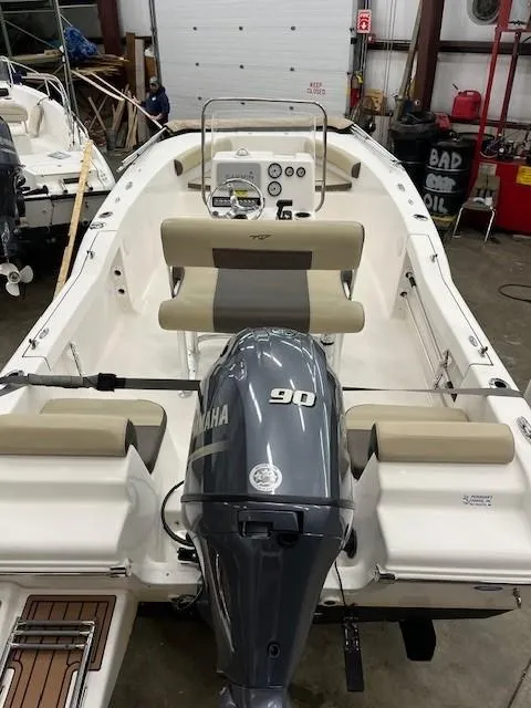 Slide: The Image of 2019 Tidewater 180CC Adventure boat with Yamaha 90 engine in a garage setting. - 20