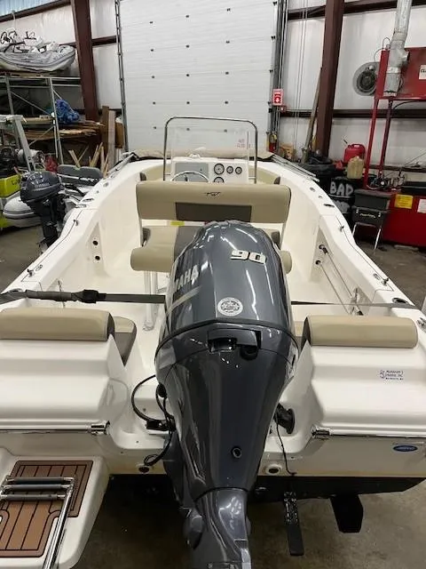 Slide: The Image of 2019 Tidewater 180CC Adventure boat with Yamaha 90 engine in a garage setting. - 21