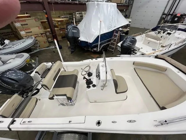 Slide: The Image of 2019 Tidewater 180CC Adventure boat in showroom, featuring Yamaha outboard motor and beige seating. - 3
