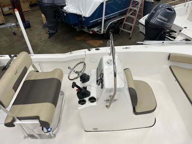 Slide: The Image of 2019 Tidewater 180CC Adventure boat interior with steering console and seating. - 4