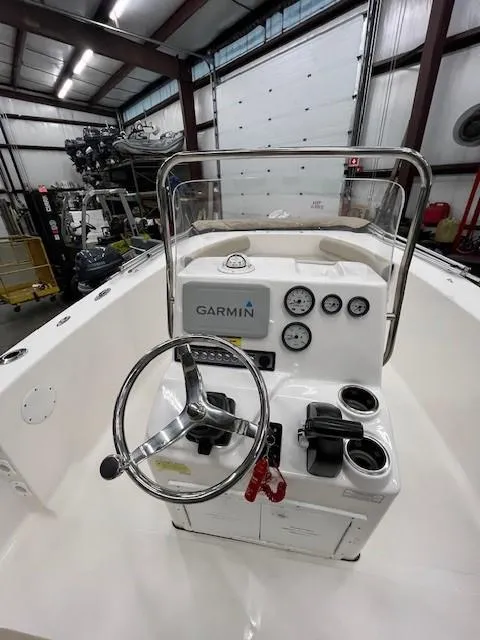 Slide: The Image of 2019 Tidewater 180CC Adventure boat console with Garmin navigation in a warehouse setting. - 7