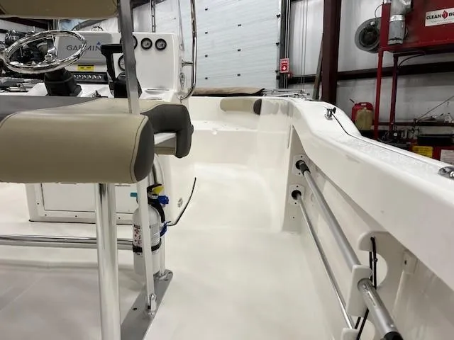 Slide: The Image of 2019 Tidewater 180CC Adventure boat interior with seating and steering console in a garage. - 9