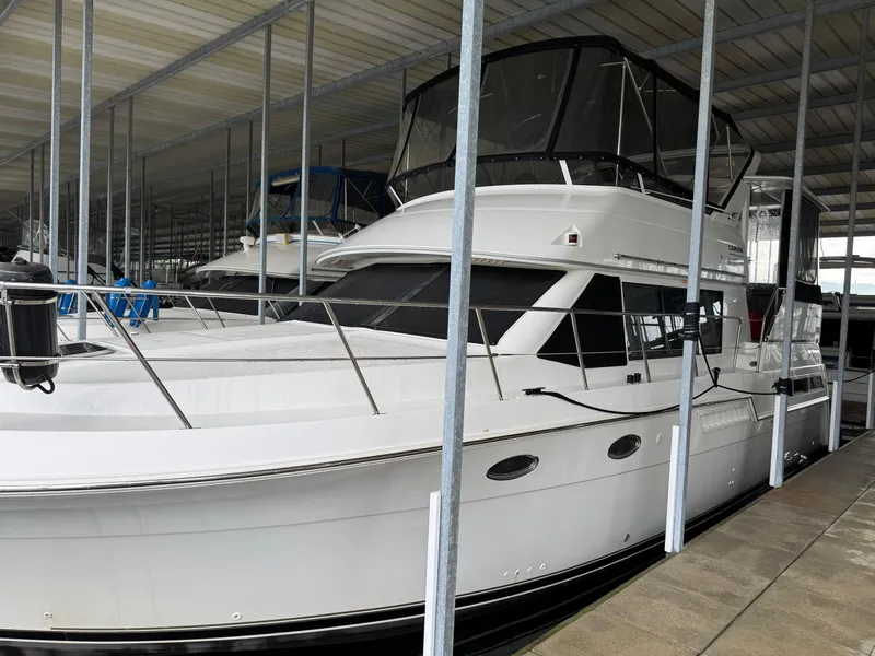 Slide: The Image of 1998 Carver 405 Aft Cabin yacht docked in covered marina. - 0
