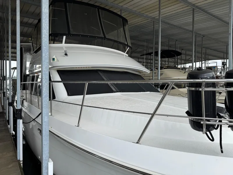 Slide: The Image of 1998 Carver 405 Aft Cabin yacht docked in a covered marina. - 1