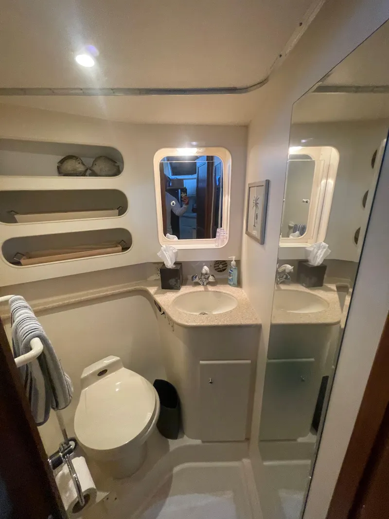 Slide: The Image of 1998 Carver 405 Aft Cabin bathroom with sink, mirror, and toilet. - 16
