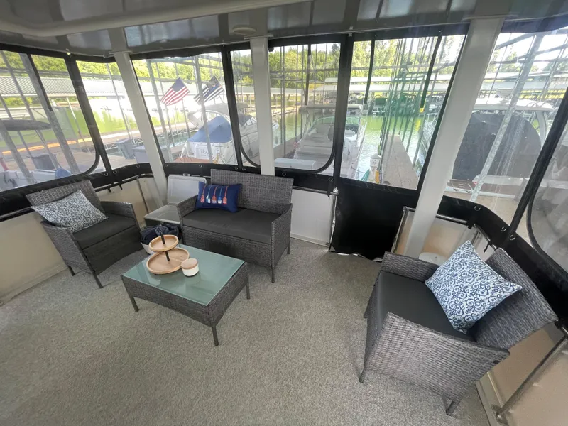 Slide: The Image of 1998 Carver 405 Aft Cabin interior with cozy seating and decorative pillows. - 19