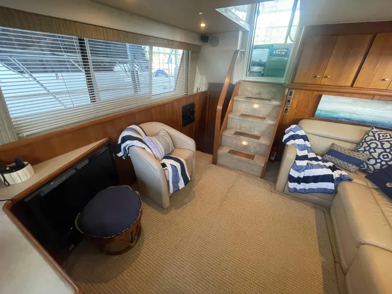 Slide: The Image of 1998 Carver 405 Aft Cabin interior with cozy seating and nautical decor. - 20