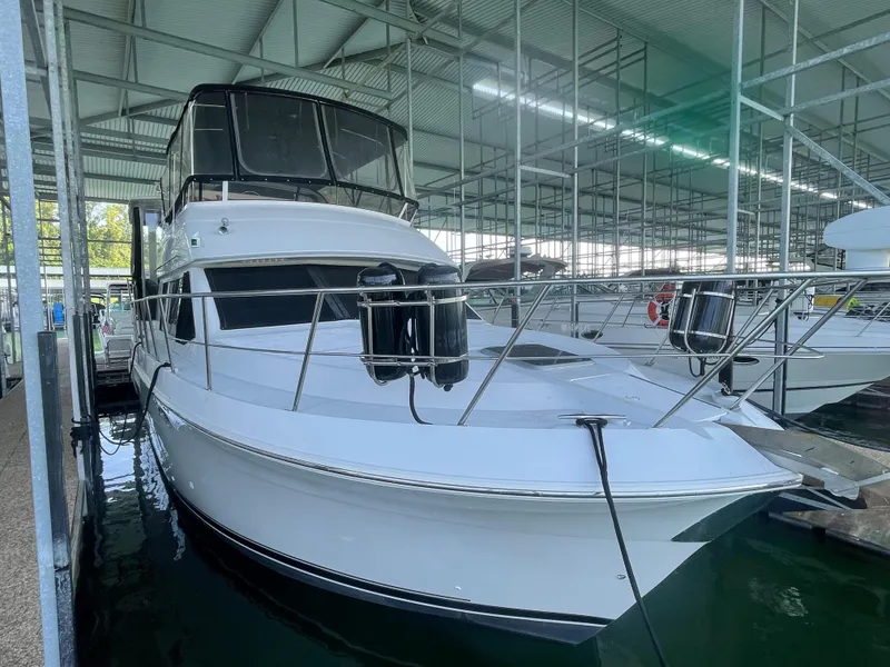 Slide: The Image of 1998 Carver 405 Aft Cabin yacht docked in a covered marina. - 3