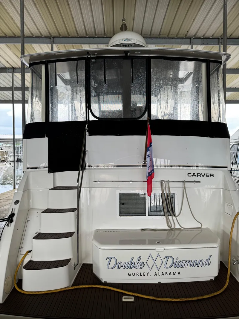 Slide: The Image of 1998 Carver 405 Aft Cabin yacht docked, featuring a "Double Diamond" nameplate. - 6