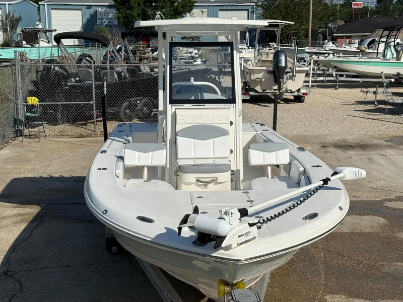 Slide: The Image of 2021 Robalo 246 Cayman boat in a marina, front view, with fishing equipment. - 10