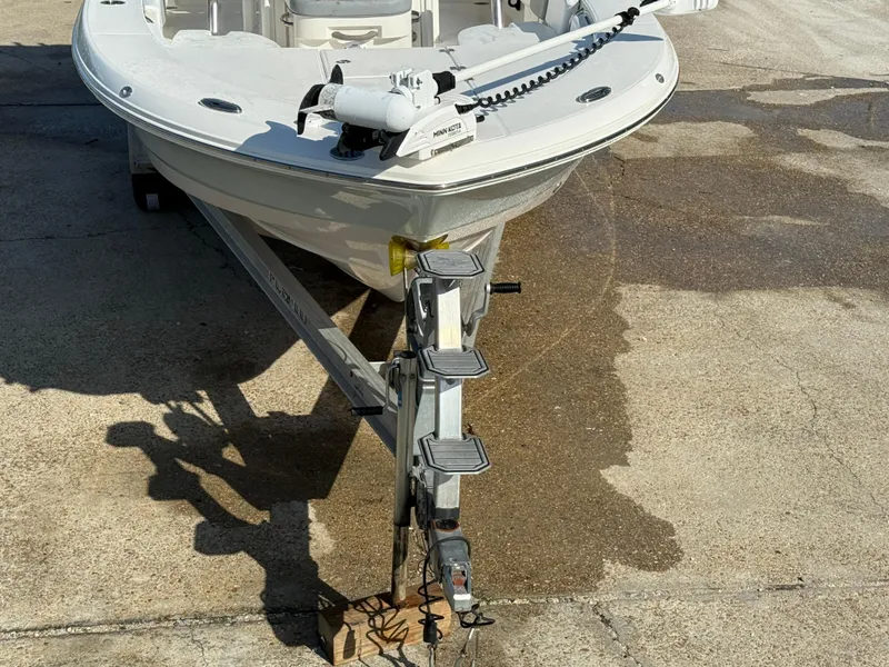 Slide: The Image of 2021 Robalo 246 Cayman boat on trailer, front view, parked on concrete. - 11