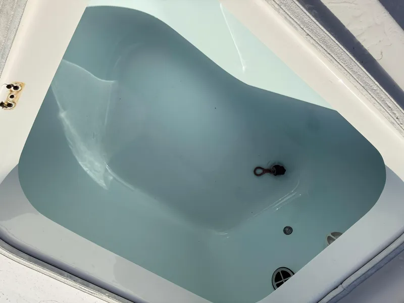 Slide: The Image of Livewell compartment on a 2021 Robalo 246 Cayman boat, filled with water. - 13
