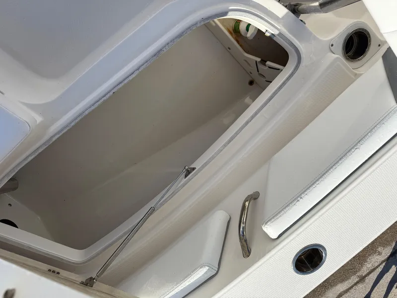 Slide: The Image of Open storage compartment on a 2021 Robalo 246 Cayman boat. - 18