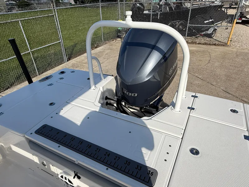 Slide: The Image of 2021 Robalo 246 Cayman boat with Yamaha engine, docked outdoors. - 24