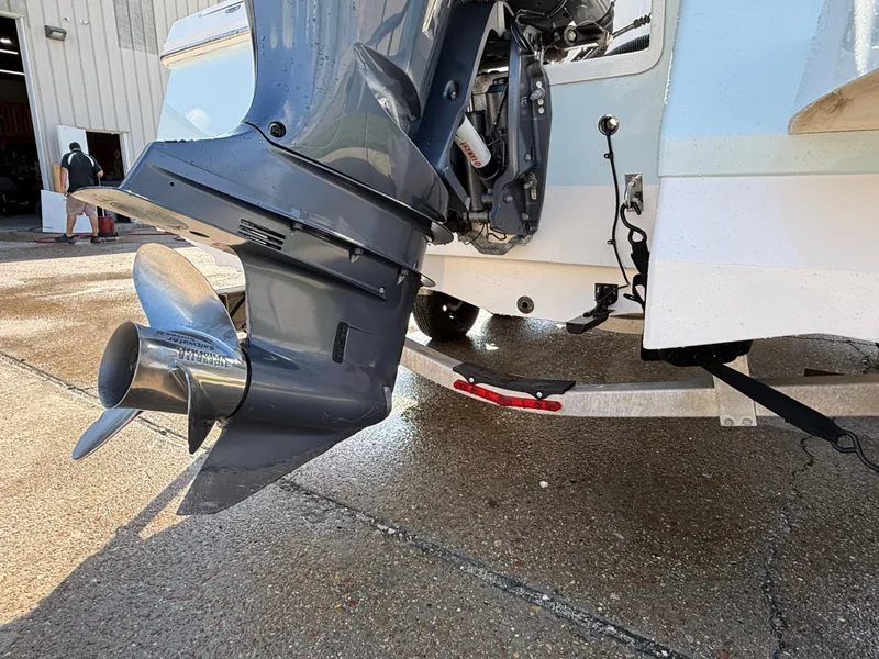 Slide: The Image of 2021 Robalo 246 Cayman boat engine and propeller close-up on a wet dock. - 27