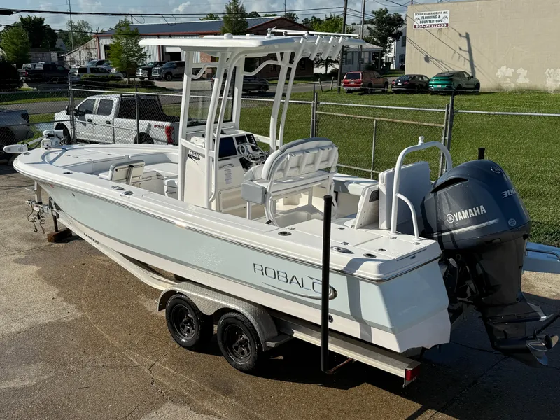 Slide: The Image of 2021 Robalo 246 Cayman boat with Yamaha engine on a trailer in a parking lot. - 3