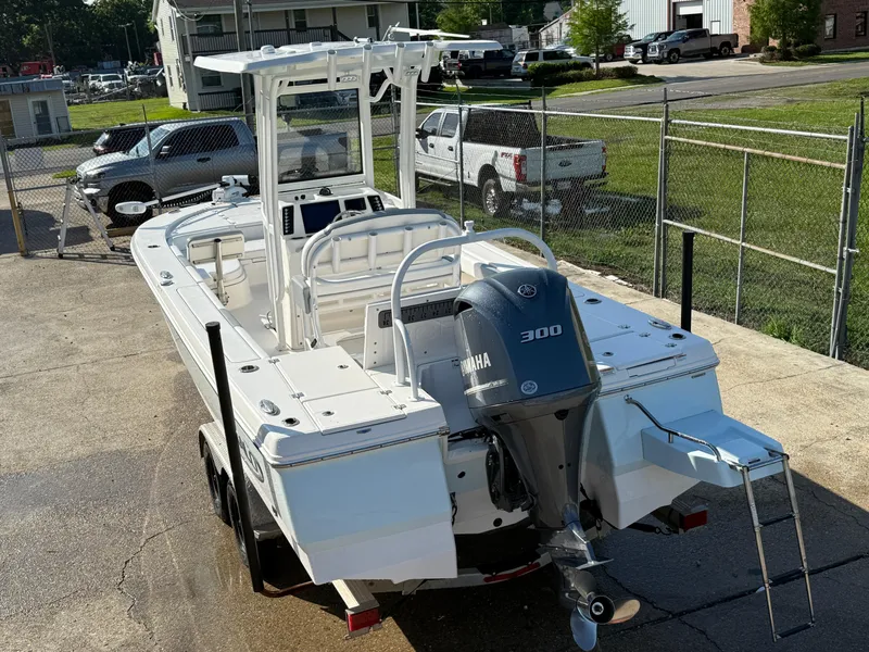 Slide: The Image of 2021 Robalo 246 Cayman boat with Yamaha 300 engine, parked on a trailer. - 6