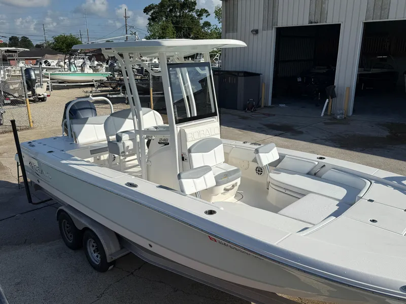 Slide: The Image of 2021 Robalo 246 Cayman boat on trailer, parked outside a building. - 9