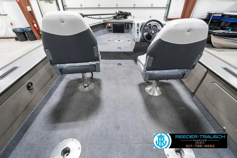 Slide: The Image of 2001 Lund 1775 Pro V SE boat interior with two seats and steering console. - 14
