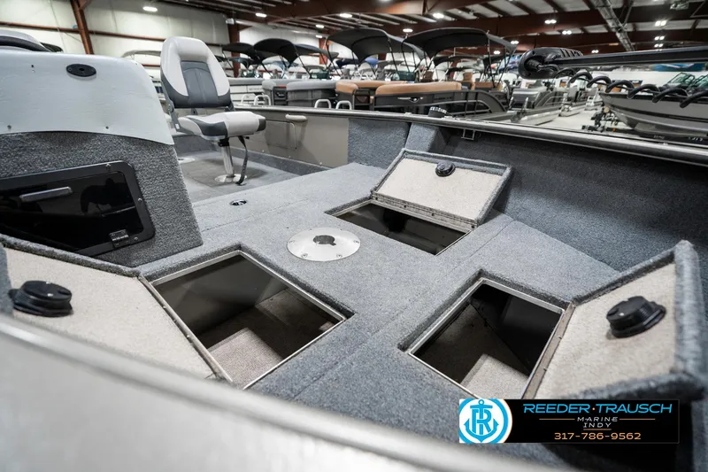 Slide: The Image of 2001 Lund 1775 Pro V SE boat interior with storage compartments in showroom. - 21