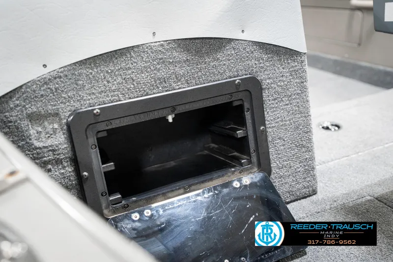 Slide: The Image of 2001 Lund 1775 Pro V SE boat storage compartment, open and empty, with carpeted interior. - 24