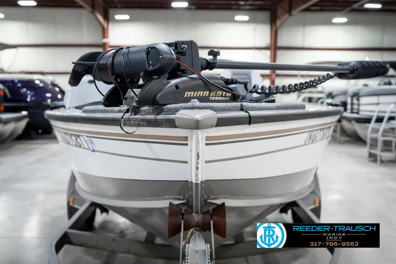 Slide: The Image of 2001 Lund 1775 Pro V SE boat with Minn Kota motor in indoor storage. - 3