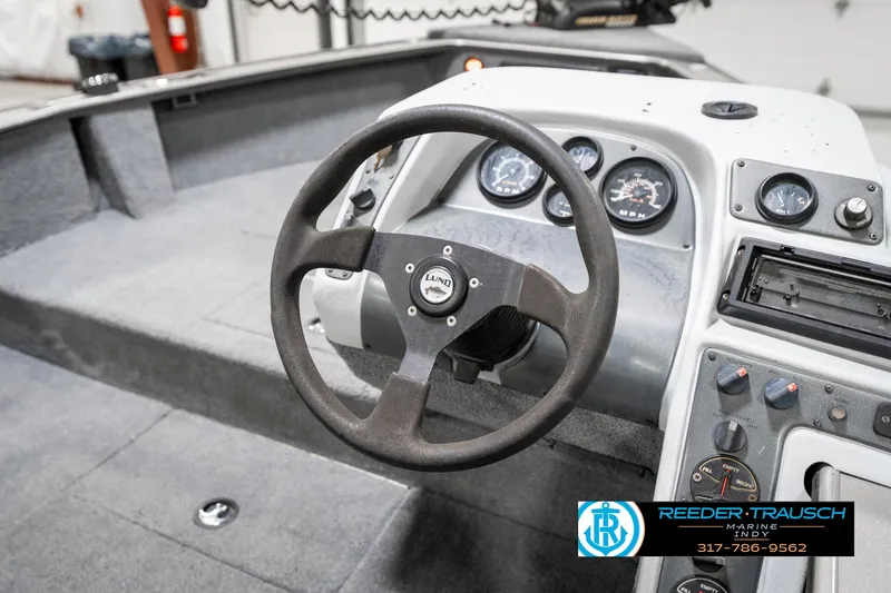 Slide: The Image of 2001 Lund 1775 Pro V SE boat dashboard with steering wheel and gauges. - 35