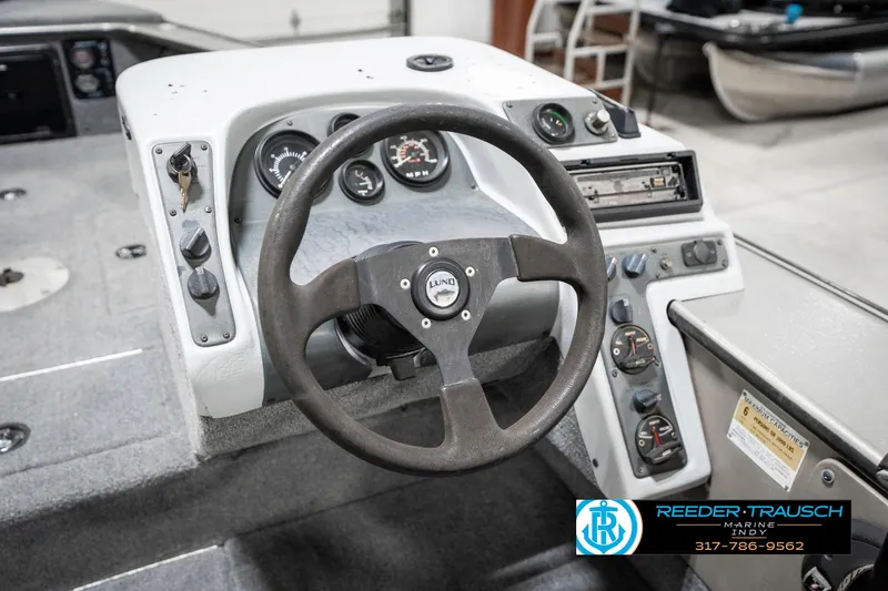 Slide: The Image of 2001 Lund 1775 Pro V SE boat dashboard with steering wheel and control panel. - 36