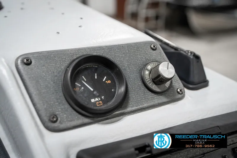 Slide: The Image of Dashboard of a 2001 Lund 1775 Pro V SE boat with battery gauge and control knob. - 40