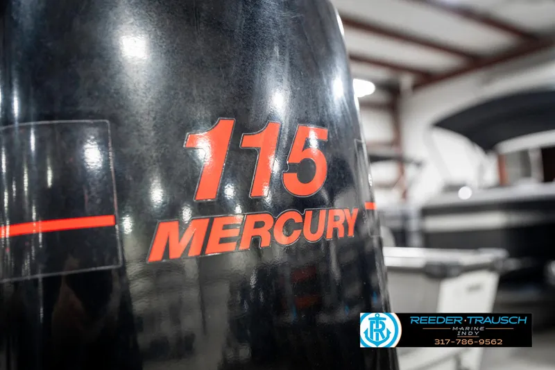 Slide: The Image of Outboard motor with "115 Mercury" branding on a 2001 Lund 1775 Pro V SE boat. - 49
