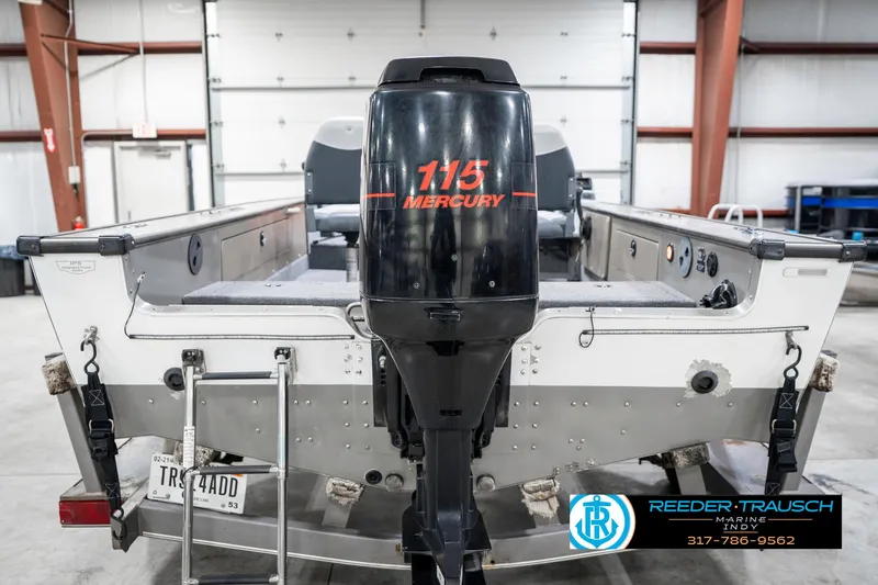 Slide: The Image of 2001 Lund 1775 Pro V SE boat with Mercury 115 outboard motor in a garage. - 7