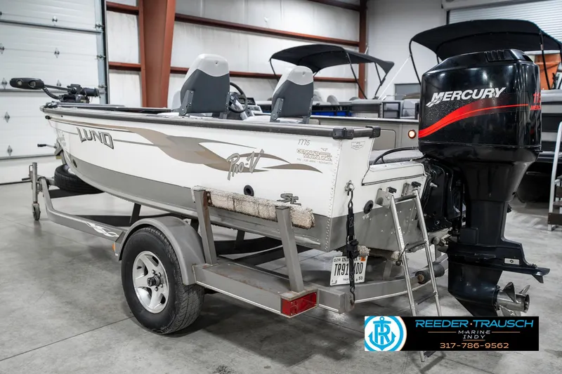 Slide: The Image of 2001 Lund 1775 Pro V SE boat on trailer with Mercury outboard motor in garage. - 8