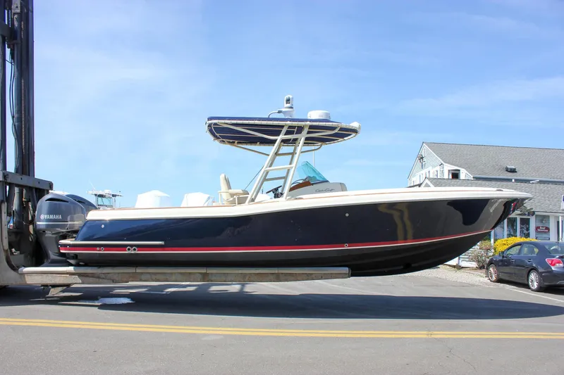 Slide: The Image of 2014 Chris-Craft Catalina 29 Sun Tender boat on forklift, side view. - 0