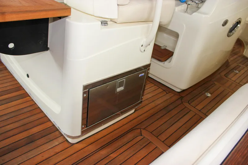 Slide: The Image of 2014 Chris-Craft Catalina 29 Sun Tender interior with teak flooring and seating area. - 10