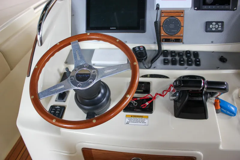 Slide: The Image of 2014 Chris-Craft Catalina 29 Sun Tender helm with wooden steering wheel and control panel. - 15