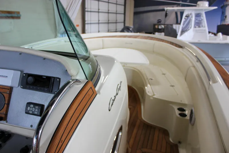 Slide: The Image of 2014 Chris-Craft Catalina 29 Sun Tender interior with wood accents and control panel. - 16