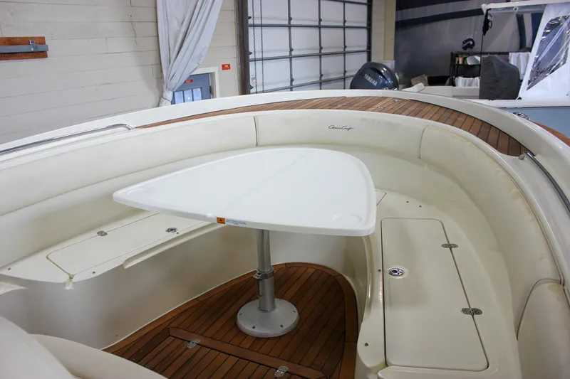 Slide: The Image of 2014 Chris-Craft Catalina 29 Sun Tender interior with seating and table, showcasing elegant design. - 17