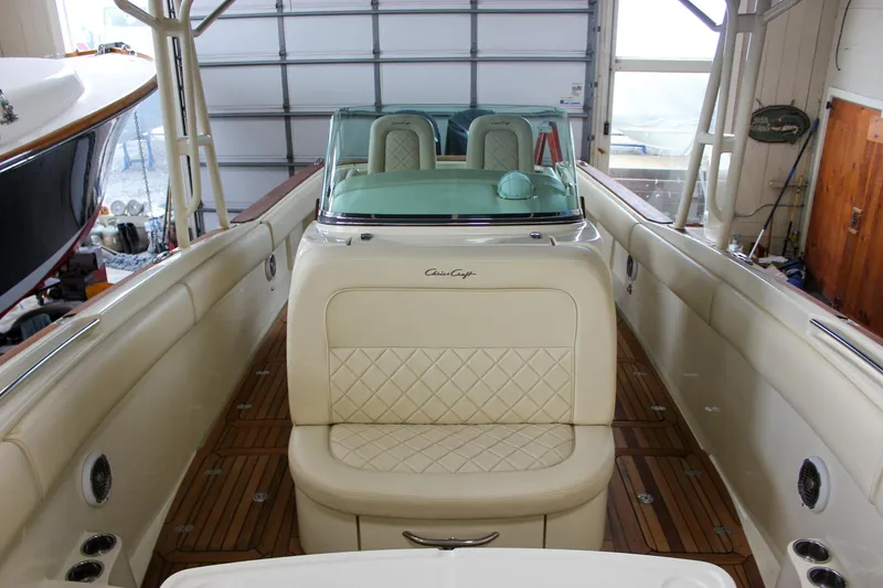 Slide: The Image of 2014 Chris-Craft Catalina 29 Sun Tender with elegant seating and teak flooring in a garage. - 18