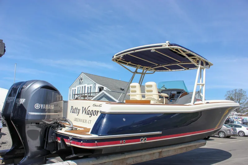 Slide: The Image of 2014 Chris-Craft Catalina 29 Sun Tender boat with Yamaha engine, docked under clear blue sky. - 2