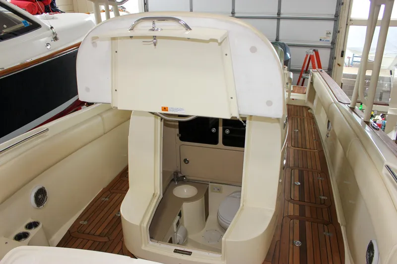 Slide: The Image of 2014 Chris-Craft Catalina 29 Sun Tender interior with open hatch and wooden deck. - 22