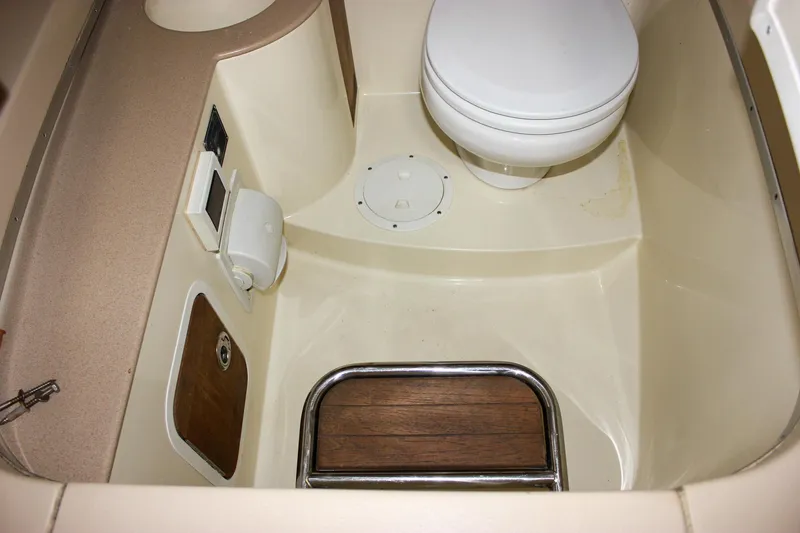 Slide: The Image of 2014 Chris-Craft Catalina 29 Sun Tender bathroom with toilet and wooden step. - 27