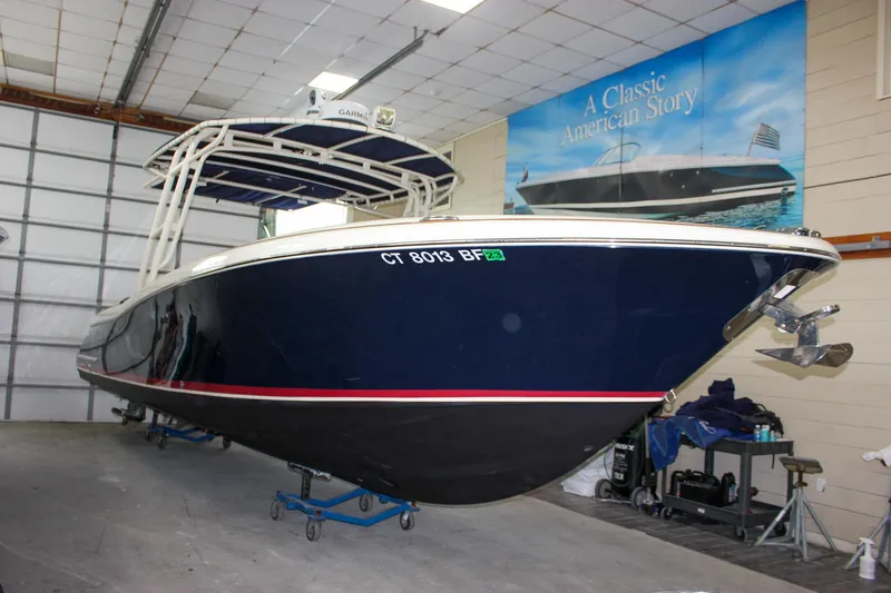 Slide: The Image of 2014 Chris-Craft Catalina 29 Sun Tender in indoor storage, blue hull, classic design. - 32